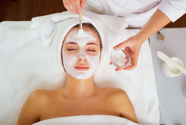 Woman in mask on face in spa beauty salon.